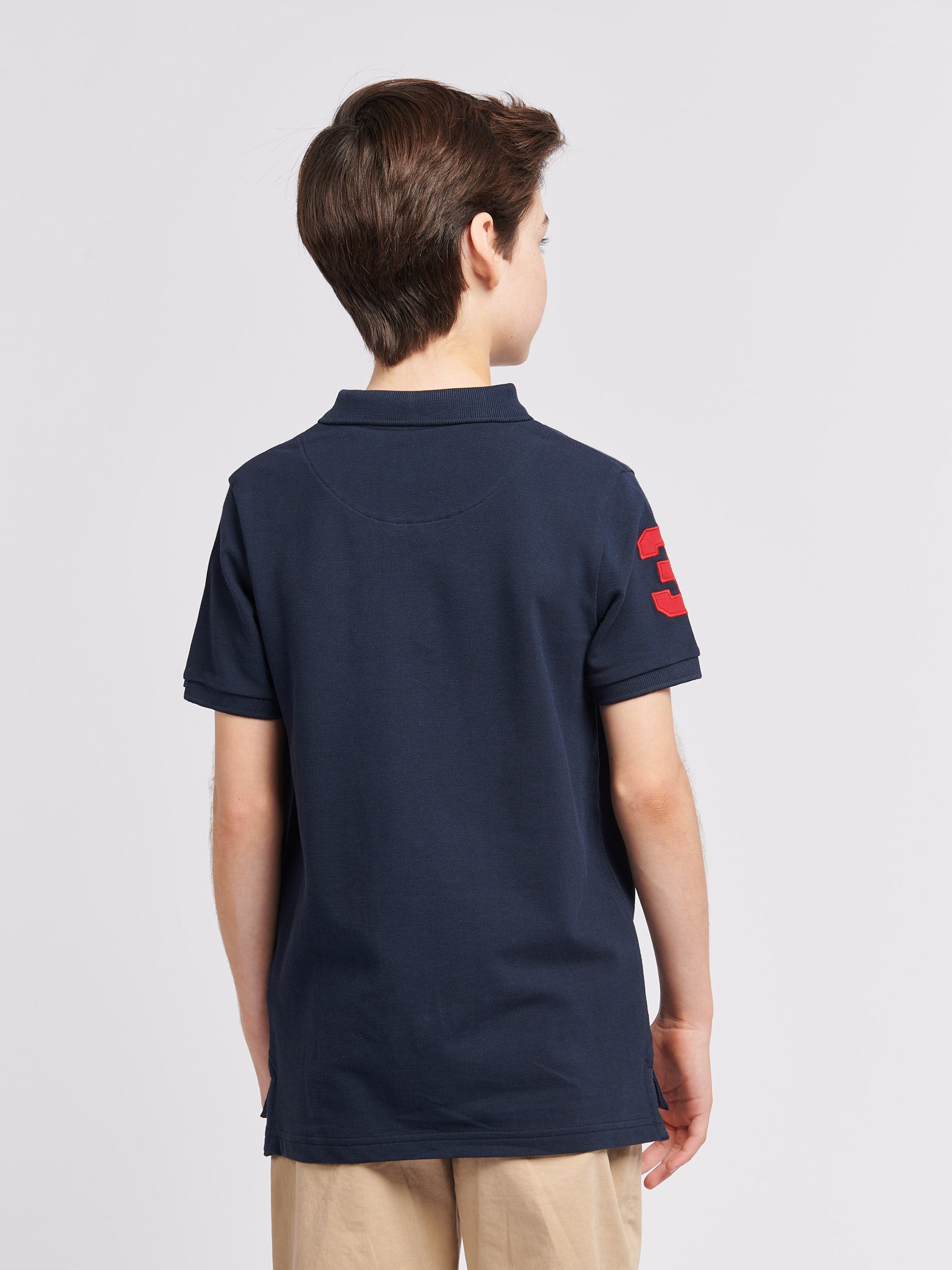 Boys Player 3 Polo Shirt in Dark Sapphire Navy / Haute Red DHM - Image 4